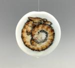 Product Description: Furbonacci Spiral Bead description:</br>Each base bead is hand shaped out of Effetre White into a 1.5 inch, quarter inch thick disc, with a domed top</br>and a flat back, the base is fully annealed, then the Furbonacci Spiral design is hand painted using Glassline</br>Paints. Once dry, the paint is flame-set at the torch for permanence and re-annealed before a final cleaning.</br>Bead Dimensions: (approx) 1.5" x 1.5" x .25."</br></br>Shipped directly from artist</br> 2021 Commemorative Bead